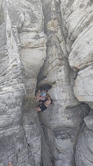 Junior orienteers in a rocky perch