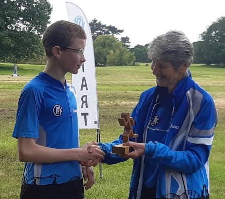 Photo of William Rowan receiving 
the Paul Thornton Trophy from Joan Selby