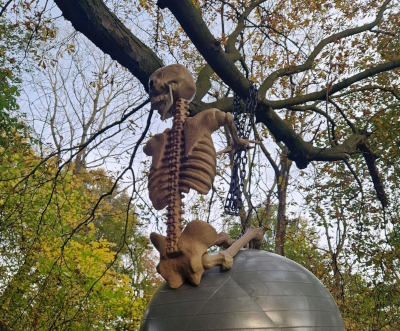 A skeleton sitting on a globe.